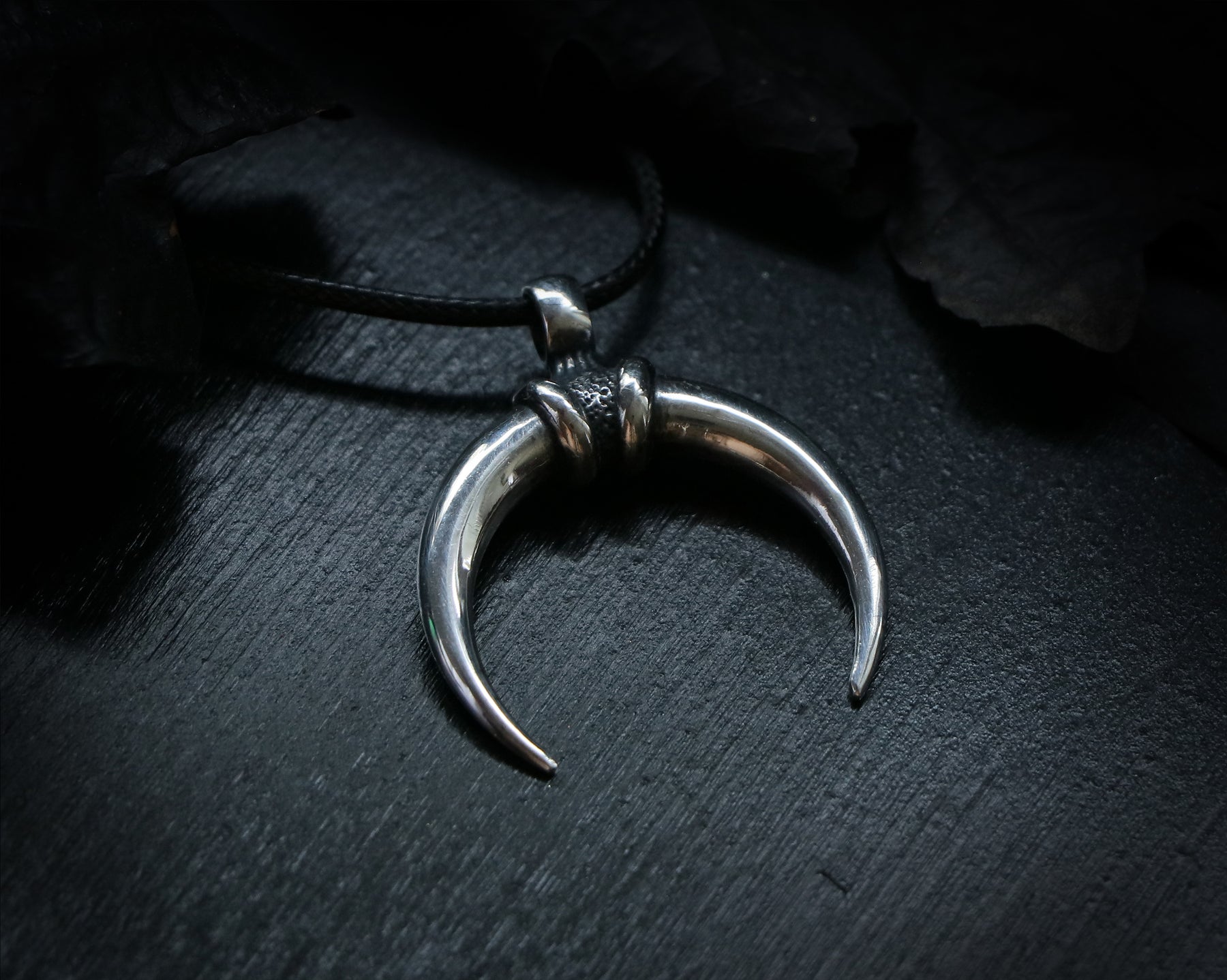 Silver crescent moon pendant related to Mithras
