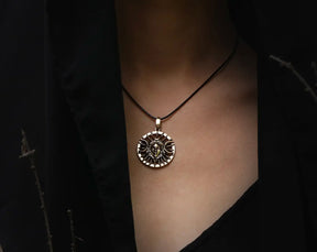 Hecate Necklace with a triple moon detailed pendant on a person against a dark background