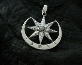 Silver Ishtar pendant with eight pointed star design and moonstone gem on a dark textured background