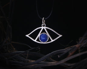 May include: Silver pendant necklace with a blue lapis lazuli stone in the center, shaped like an eye with a triangle inside.