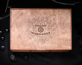 May include: A wooden box with a laser-engraved logo that says "Pagan Workshop" inside a triangle with a crescent moon and sun symbol. 