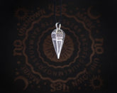 May include: Silver pendant necklace with a pyramid-shaped charm featuring an eye design. The charm is hanging from a black cord.