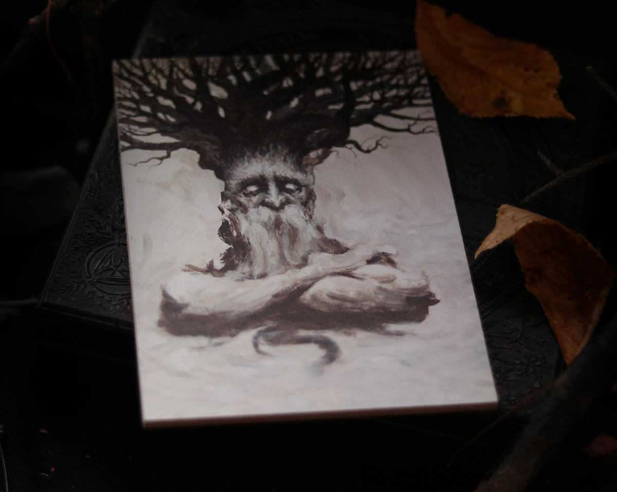 May include: A black and white illustration of a tree spirit with a large, gnarled tree growing from its head. The spirit has a long, white beard and is sitting with its arms crossed.