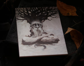 May include: A black and white illustration of a tree spirit with a large, gnarled tree growing from its head. The spirit has a long, white beard and is sitting with its arms crossed.