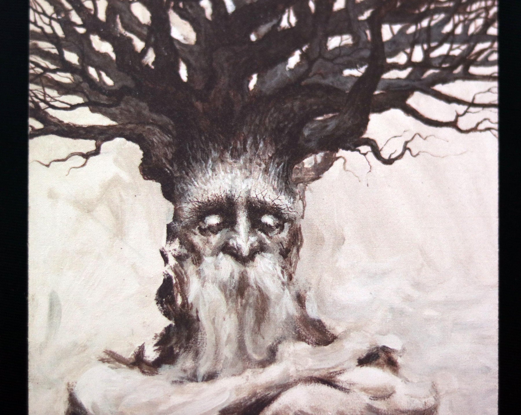 May include: A watercolor painting of a tree with a human-like face. The tree has a long white beard and is depicted with a sad expression. The background is a light gray color.