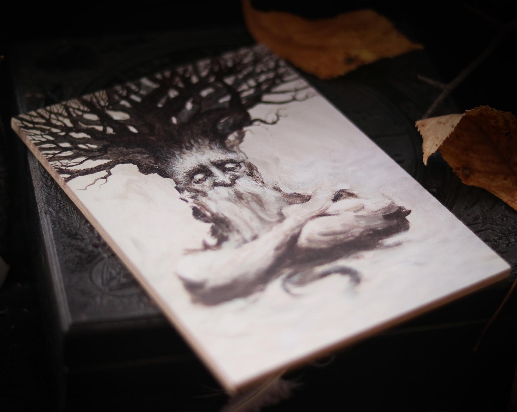 May include: A black and white illustration of a tree with a human face and beard. The tree is depicted with gnarled branches and a thick trunk. The face is expressive with a furrowed brow and a thoughtful expression.