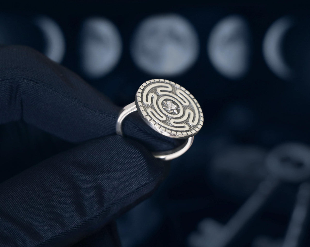 Sterling silver Hecate Strophalos ring with central gemstone. Handcrafted occult jewelry by Pagan Workshop, showcasing ancient goddess symbolism.