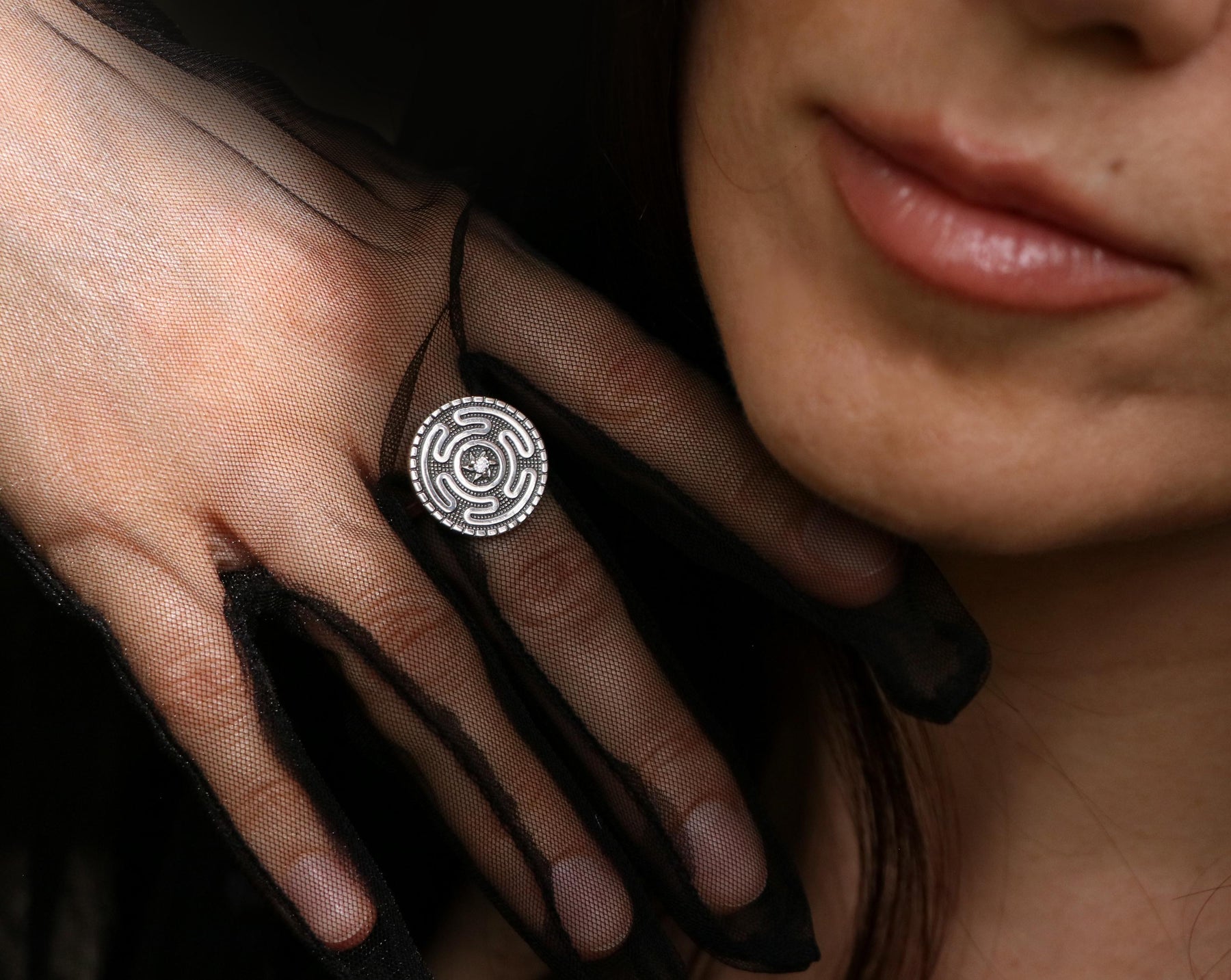 Model wearing a handcrafted Hecate Strophalos ring in sterling silver. Witchy aesthetic jewelry with a mystical vibe.