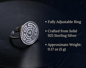 May include: A sterling silver adjustable ring with a circular design. The ring features a detailed pattern and a small, central gemstone. The text on the image says it is crafted from solid 925 sterling silver and weighs approximately 0.17 oz.