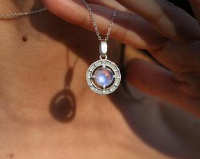 Natural iridescent moonstone set in moon phases pendant