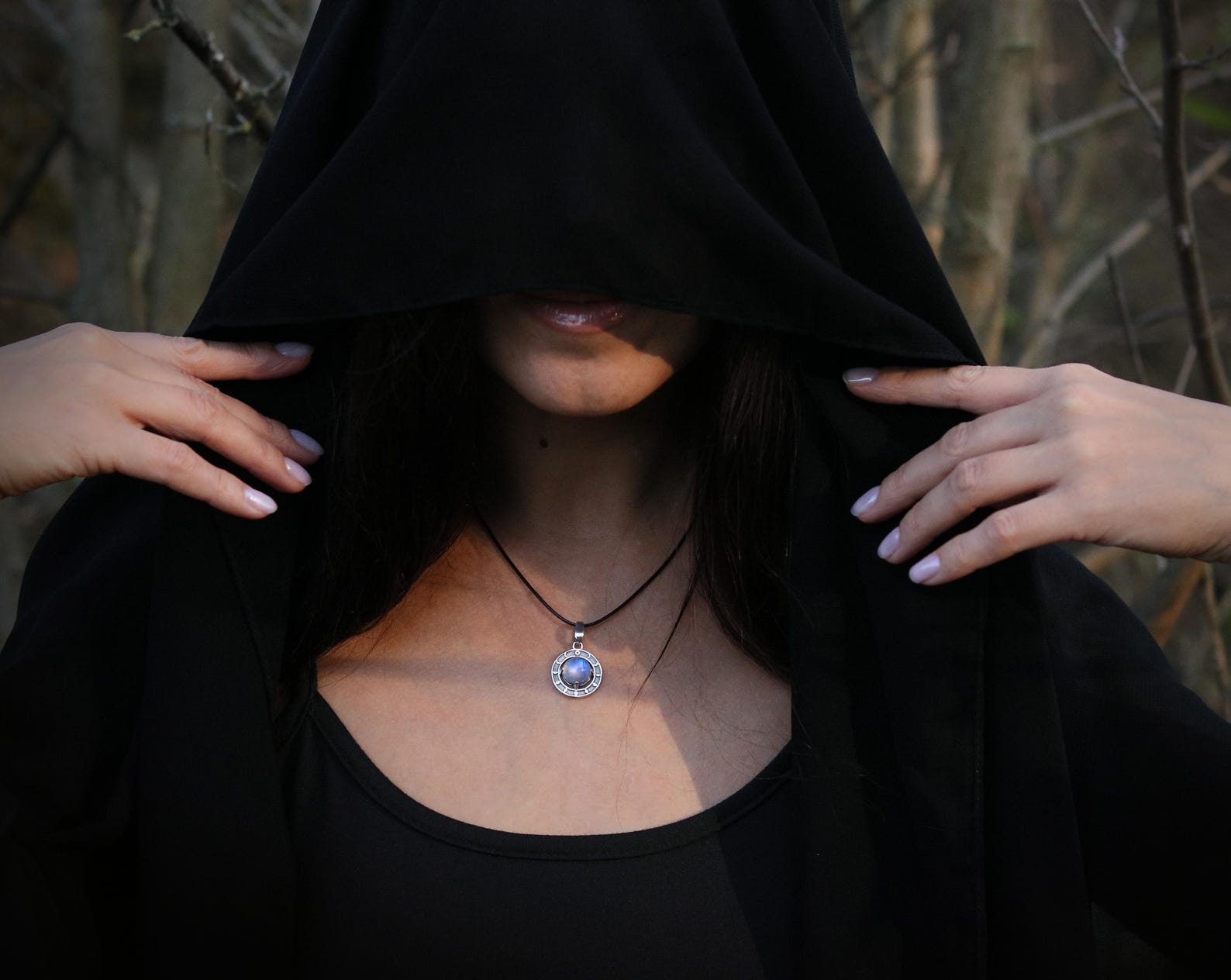 Moonstone moon phases pendant worn on adjustable black cord