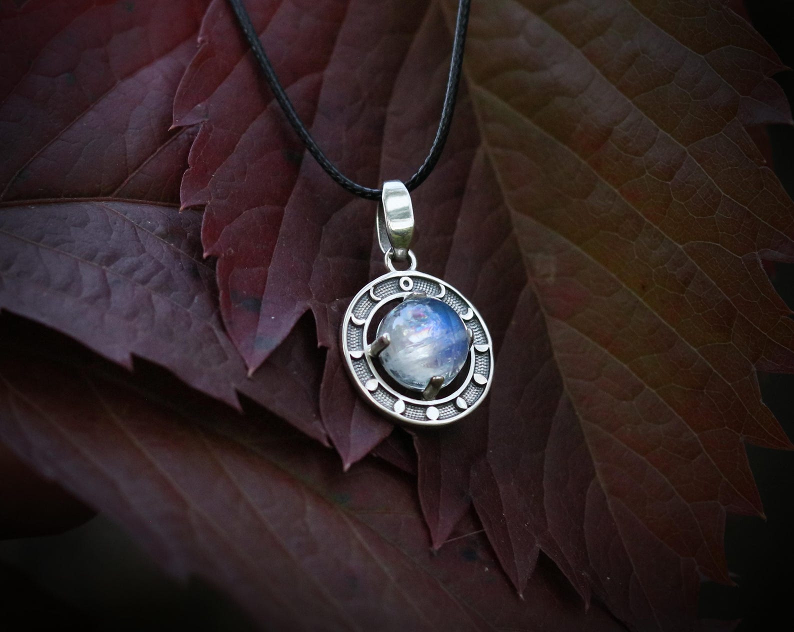 Moonstone pendant with phases of the moon in sterling silver