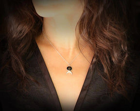 crescent moon pendant worn on model