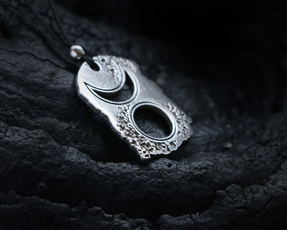 Silver pendant of the power of the wicca goddess on crescent moon amulet